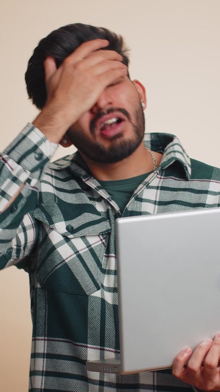 Indian man working on laptop loses becoming surprised by lottery results bad news fortune loss fail
