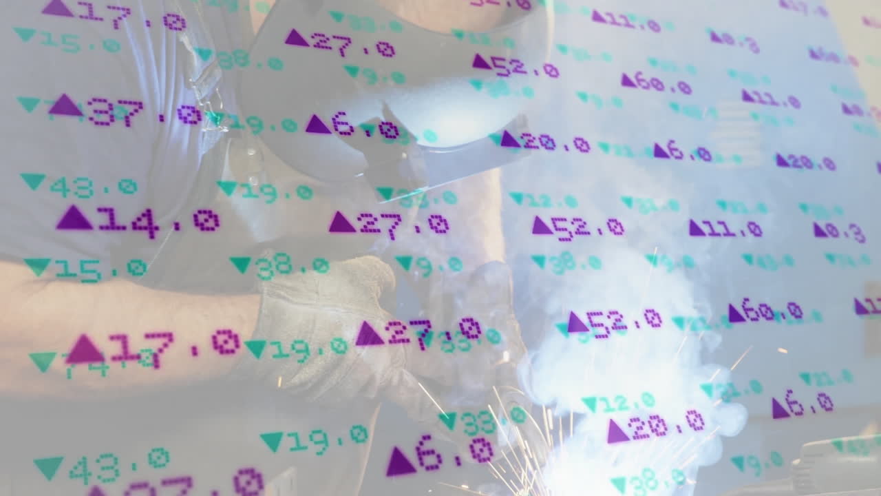 Senior male welder operating welding torch on shop, displaying animated purple green finance data