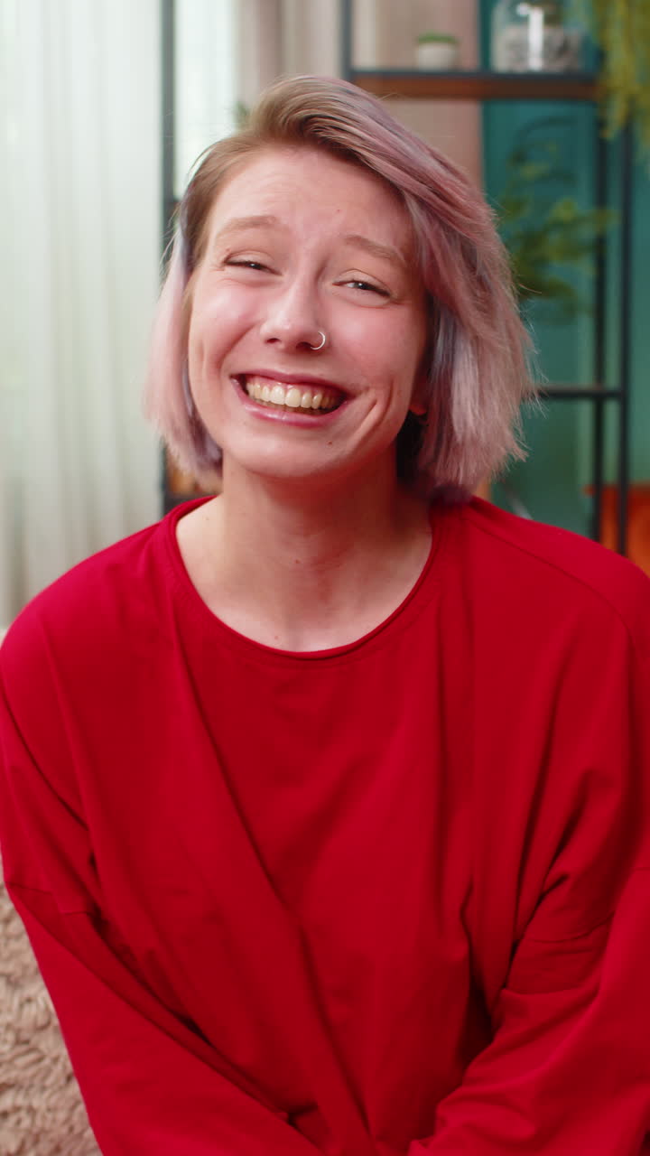 Woman genuinely laughing smiling positively into camera joyful cheerful happy facial expression
