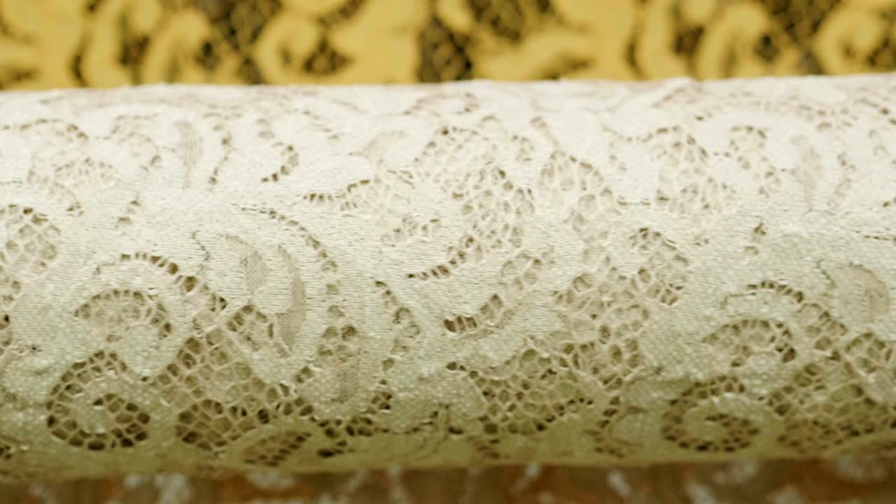 una foto macro de un encaje, tela utilizada para hacer elegantes vestidos de novia para el día de la boda.