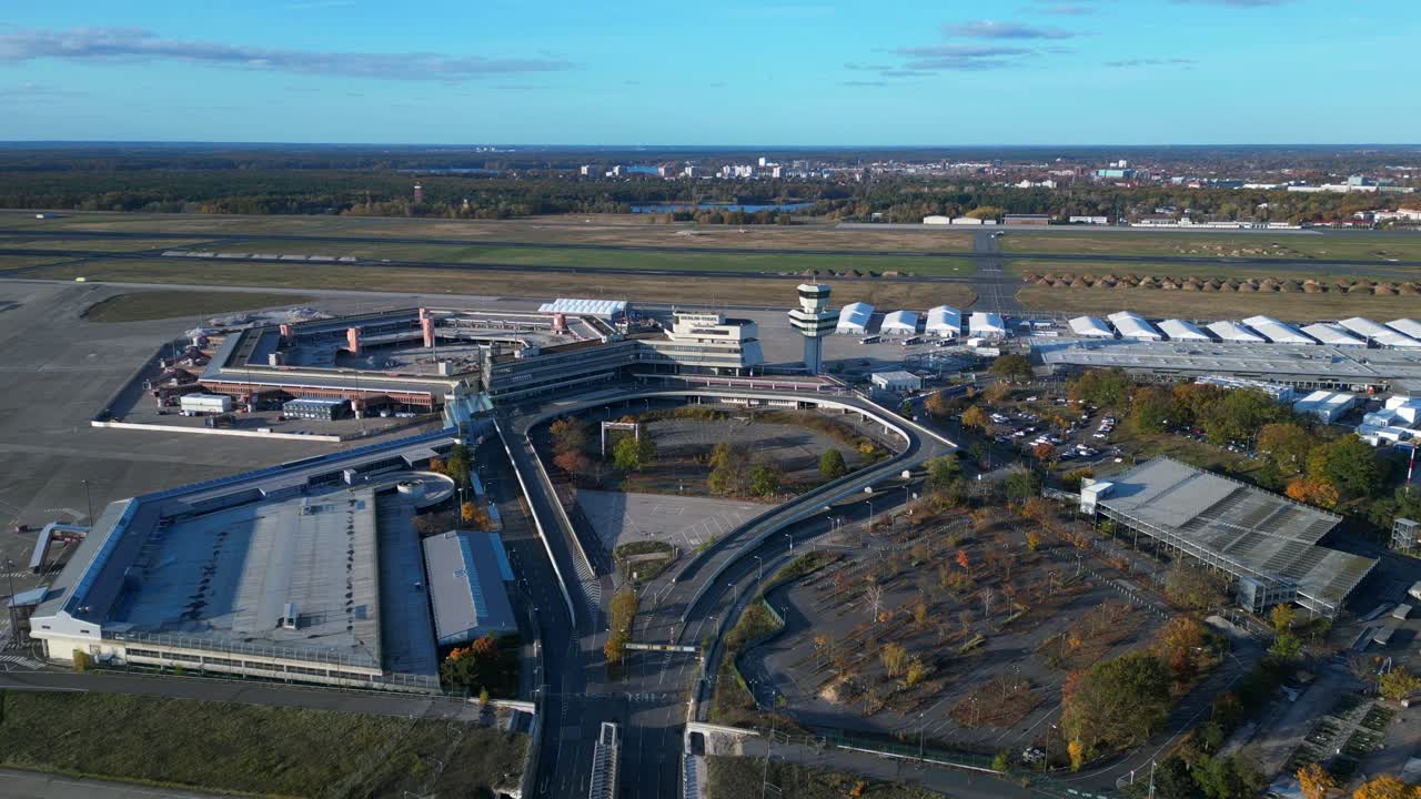 berlin tegel airport showing the main terminal, control tower, hangars. Now Refugee home. Smooth aerial view flight panorama overview drone