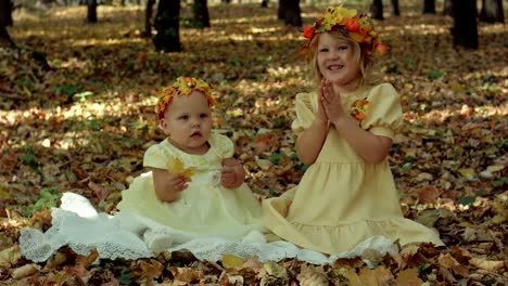 little baby and girl in the autumn park