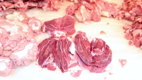 hand arranging beef slices into a rose shape