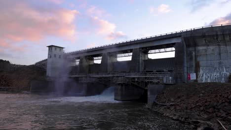 Dam-with-blue-sky-and-open-gate,-with-running-water-winter,-Mist,-morning-sunrise,-Georgia,-USA