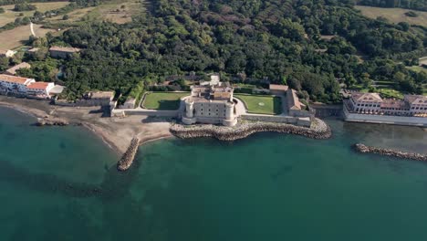 circling around a castle on the italian coast from the sky