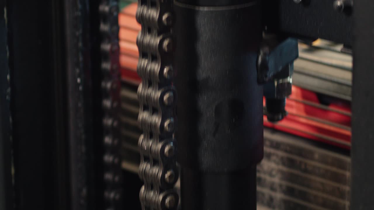 Tilt down along forklift mast chain and fork assembly, tilt down