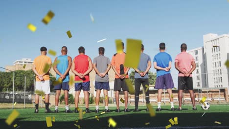 Animation-of-confetti-falling-over-back-view-of-male-football-team-on-pitch