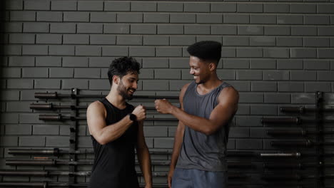 two men smiling in a gym