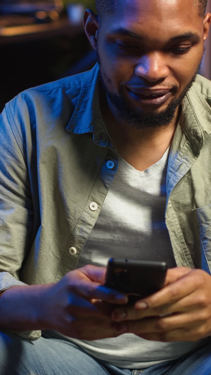 Vertical Video Carefree freelancer chatting with friends over text messages on phone