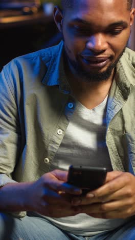 vertical video carefree freelancer chatting with friends over text messages on phone