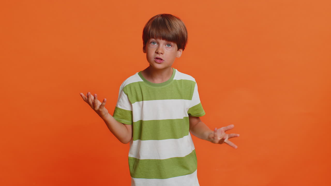 Confused puzzled preteen child boy kid pointing fingers himself not guilty not my fail innocently