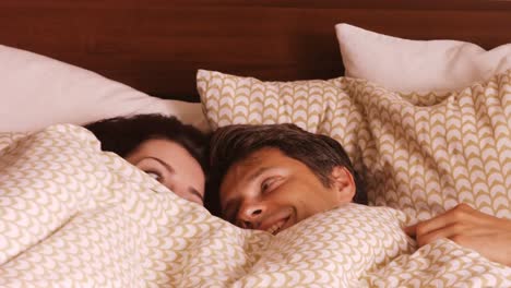 couple relaxing on bed in the bedroom