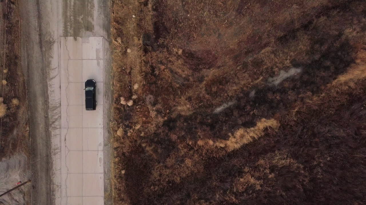 Upland game hunting area with travelers in a terrain vehicle, aerial high angle shot