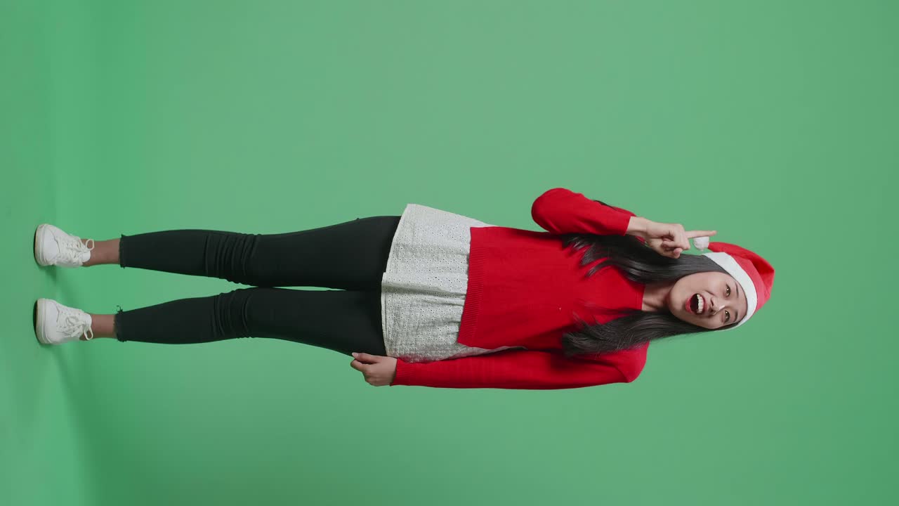 Woman wearing a Santa hat and red sweater