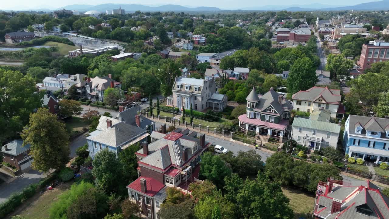 American neighborhood with historic Victorian houses, tree-lined streets and a small-town atmosphere in USA. Aerial top down shot. Colorful rooftops and classic residential architecture in Virginia