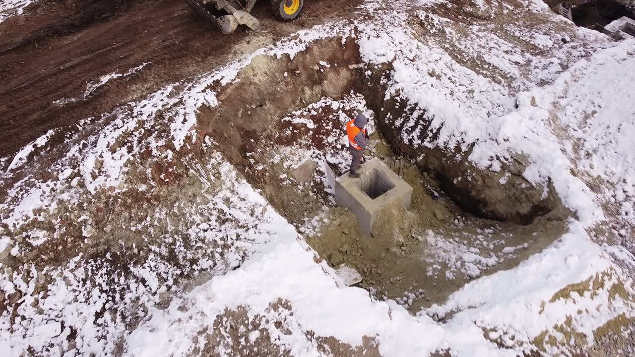 Construction Site in Winter with Excavation and Tractor