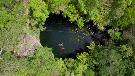 drone shot over a cenote - quintana roo - mexico