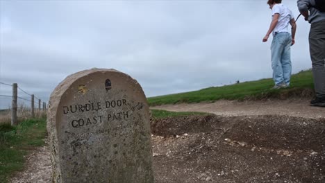 gravestone on a walking path: durdle door, south coast of england