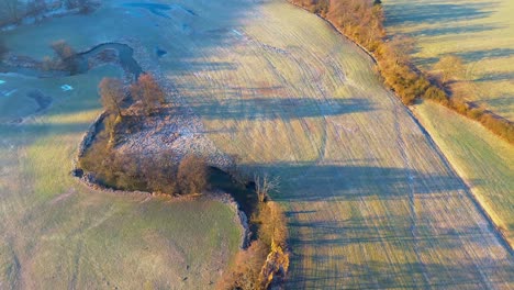 frosty dawn over serene farmland with natural pond