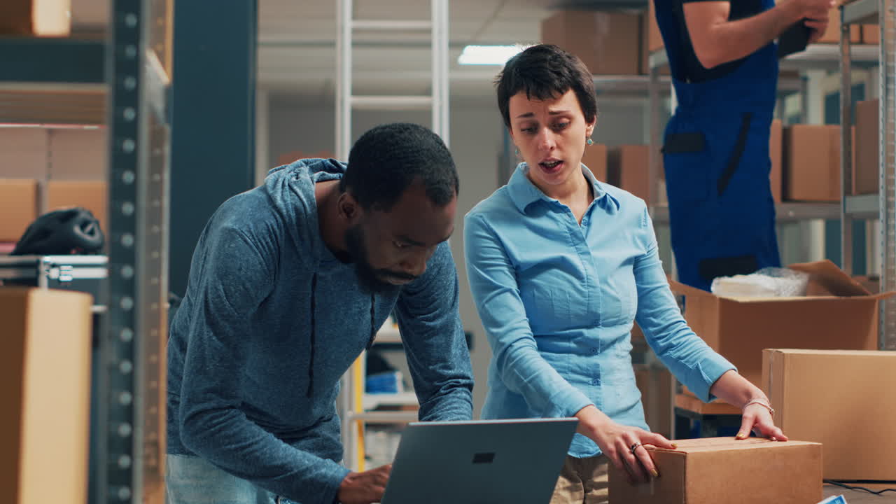 Warehouse employees packing boxes for shipping