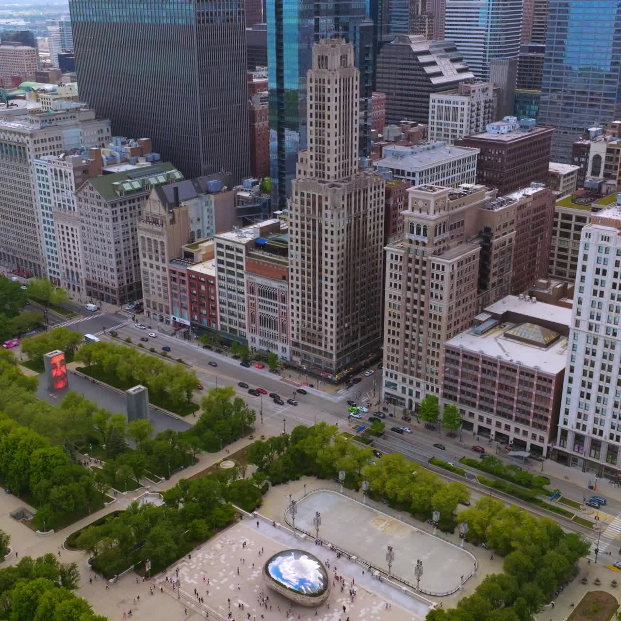 Amazing buildings towering over the road full of cars. Green park areas neighboring with dense architecture