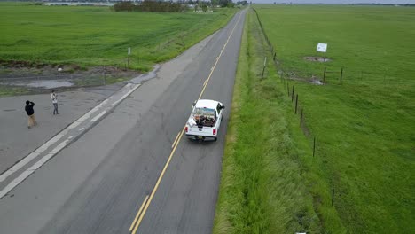 Truck-drives-down-rural-farm-road