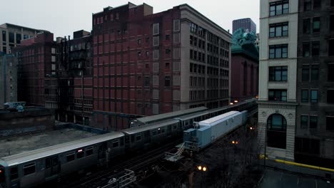 chicago elevated subway train traveling through downtown loop in the evening drone