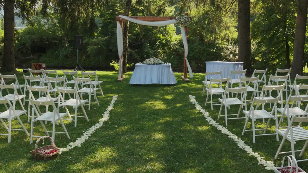 Bridal canopy of a civil wedding ceremony in a garden.Tilt up reveal
