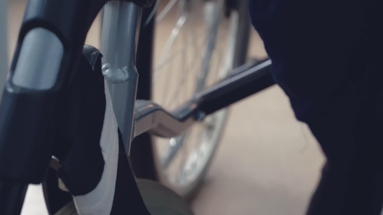 젊은 남자가  ⁇ 체어에  ⁇ 드레일을 고쳐줍니다.