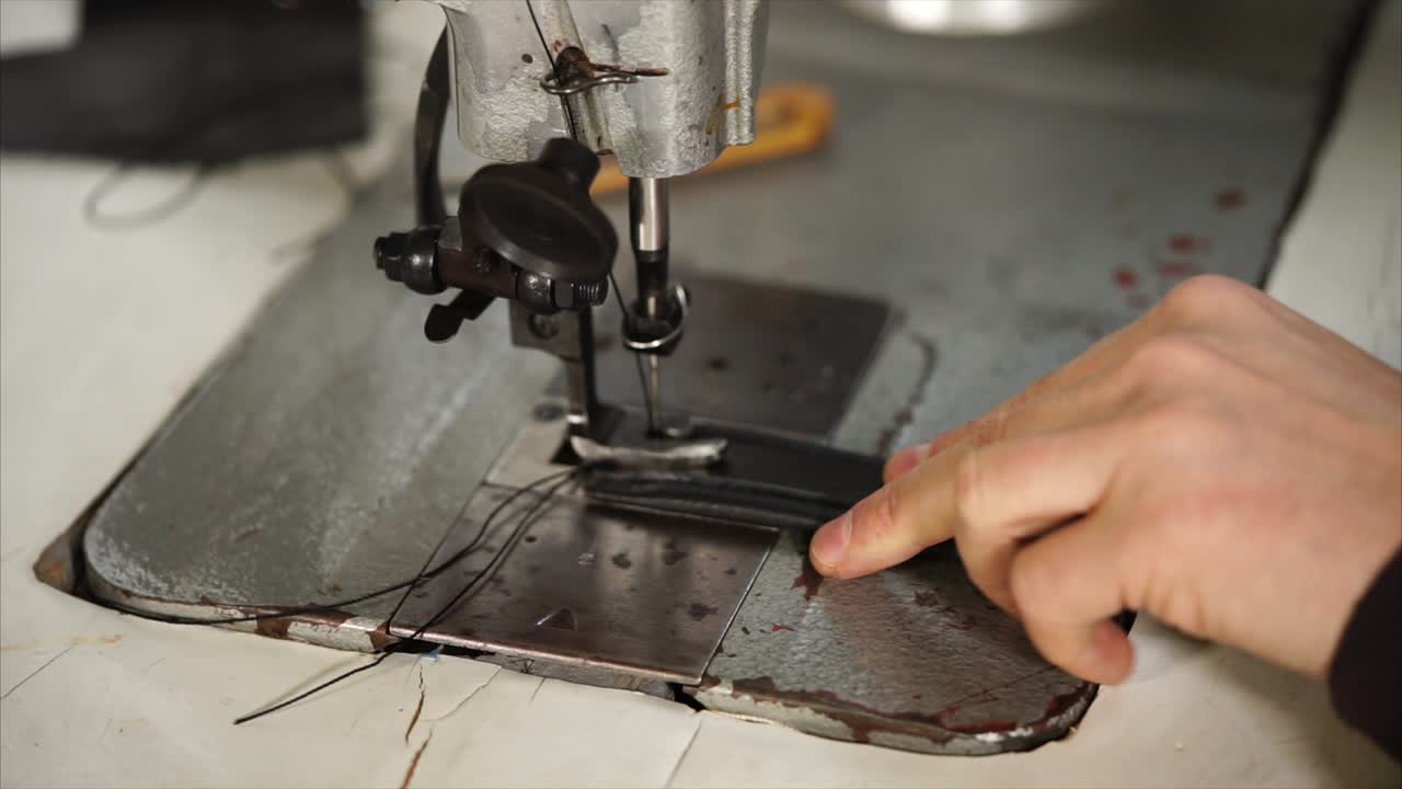 Person working on a vintage sewing machine
