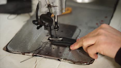 person working on a vintage sewing machine