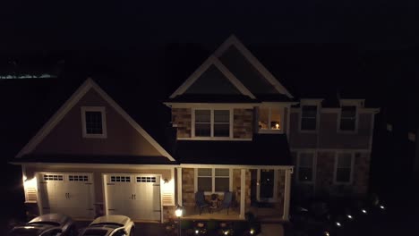 large upscale new home in neighborhood at night