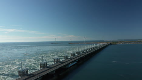 Aerial-View-Of-Eastern-Scheldt-Storm-Surge-Barrier-And-Wind-Turbines-In-Neeltje-Jans-Nature-Reserve-In-Zeeland-Province,-Netherlands