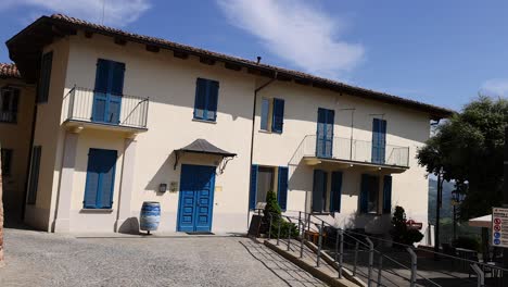 brick wall beside italian building with blue doors