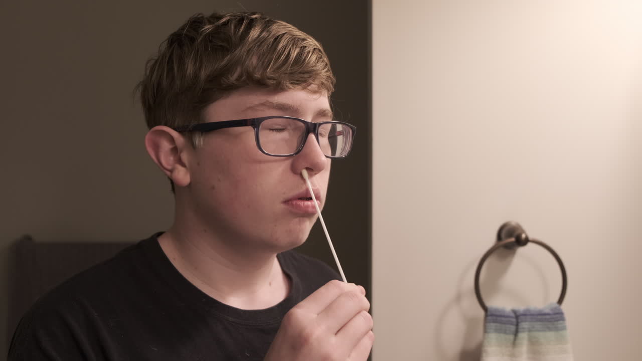 Teenage boy takes an at home corona virus or covid 19 test