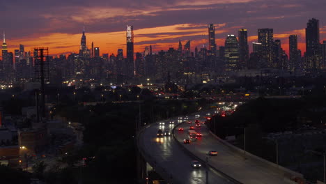 aerial view of freeway traffic entering new york city at night