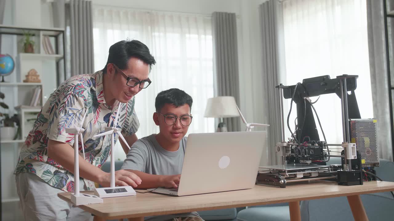 Father and Son Learning about 3D Printing and Renewable Energy