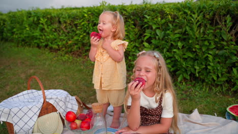 sisters enjoying a picnic with peaches