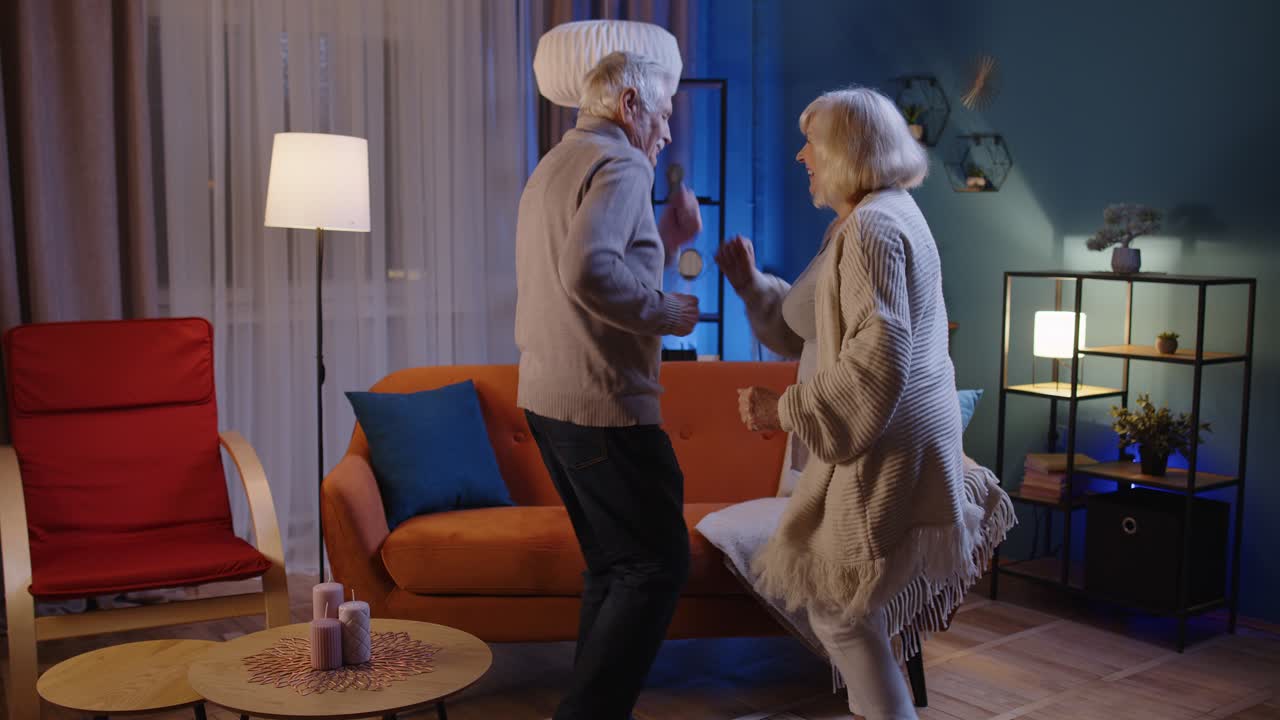 행복한 노인 커플 집에서 춤을 추고 휴식을 취하고 현대 음악으로 재미를 느끼고 집에서 미소 짓고