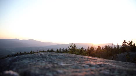 timelapse of sunset at the top of the green mountains in vermont, with the camera set on the rocks