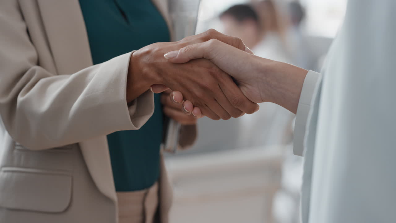 close up business people shaking hands  corporate partnership deal welcoming opportunity for cooperation in office