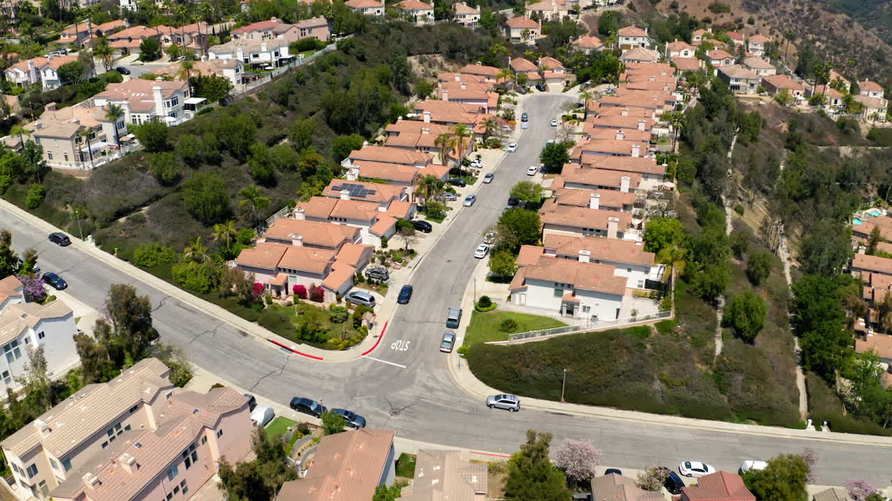 Aerial view of a suburban residential neighborhood nestled in hills