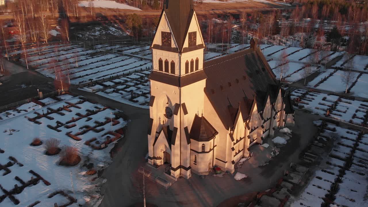 Areal close up of majestic Scandinavian church-cemetery in Vindeln, Sweden. Shoot on a cold snowy morning.