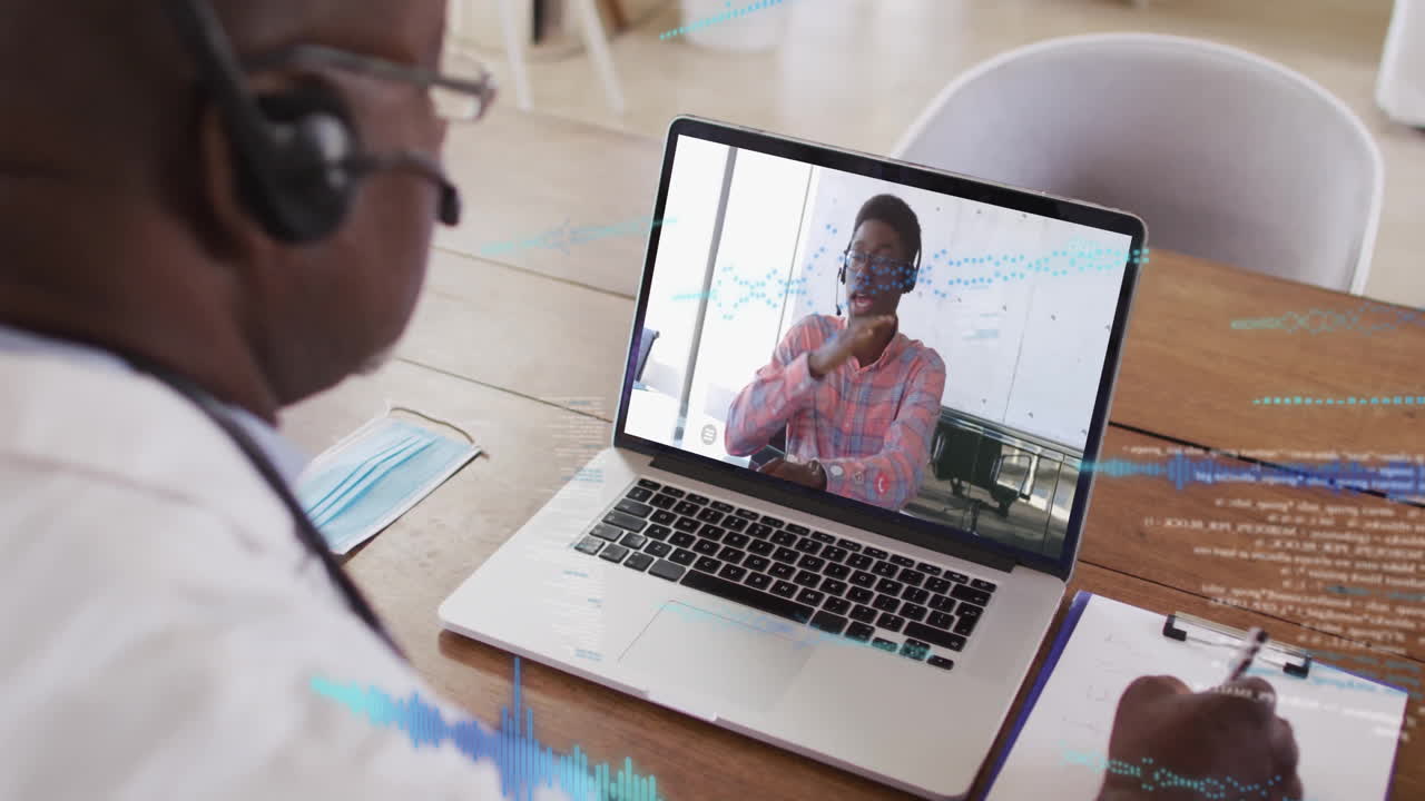 In office, two people on laptop having animation video call conversation