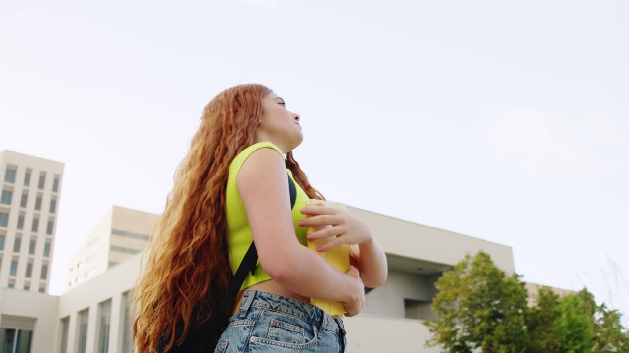 Young redhead student on college campus