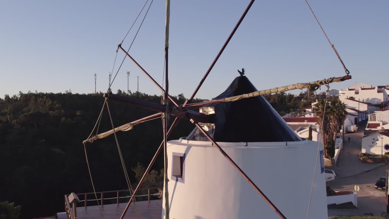 해가 뜨면 아무도 없는 odeceixe의 오래된 전통적인 풍차 위를 날아다니는, 공중