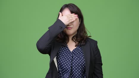 mature beautiful asian businesswoman covering eyes as three wise monkeys concept
