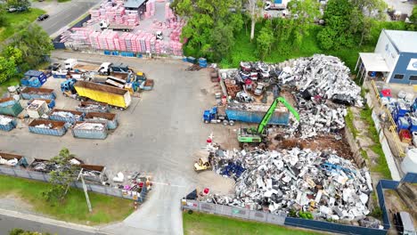 machines moving scrap metal in industrial yard