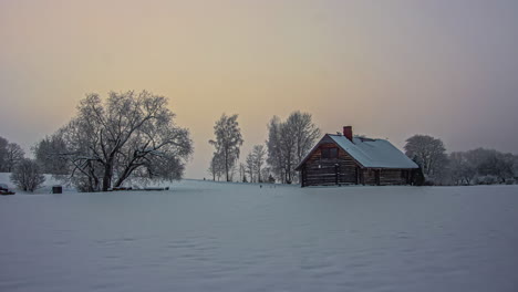time lapse shot of sunset hiding behind dense clouds in the evening on snowy day in wilderness