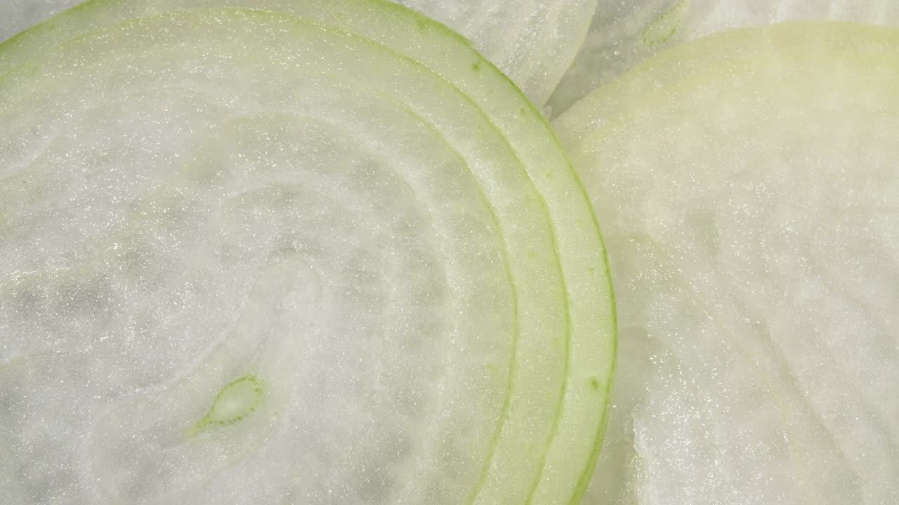 A close-up onion. Slices of onions. Slicing in circles. Raw onions.